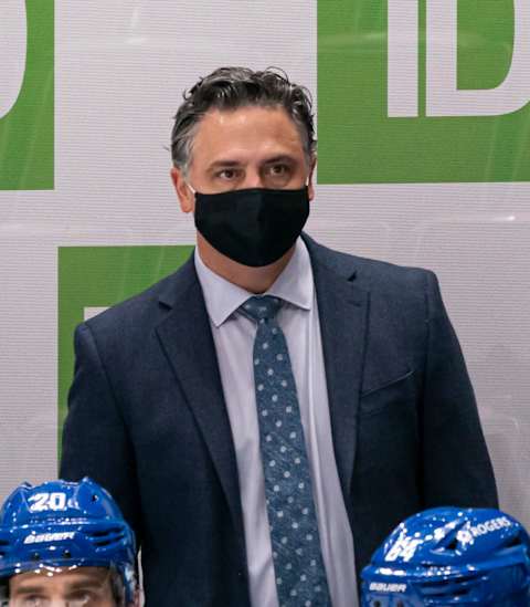 VANCOUVER, BC – JANUARY 20: Head Coach Travis Green of the Vancouver Canucks wears a mask behind the bench during NHL hockey action against the Montreal Canadiens at Rogers Arena on January 20, 2021 in Vancouver, Canada. (Photo by Rich Lam/Getty Images)