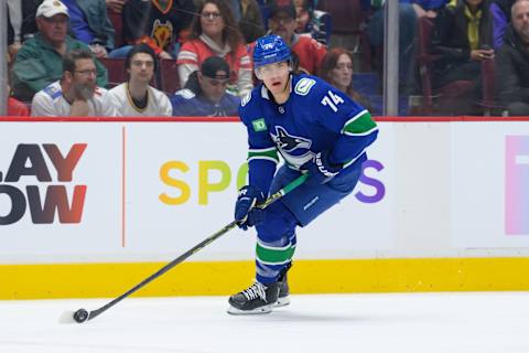 VANCOUVER, CANADA – MARCH 31: Ethan Bear #74 of the Vancouver Canucks skates with the puck during the second period of their NHL game against the Calgary Flames at Rogers Arena on March 31, 2023 in Vancouver, British Columbia, Canada. (Photo by Derek Cain/Getty Images)