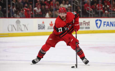 DETROIT, MICHIGAN – DECEMBER 13: Filip Hronek #17 of the Detroit Red Wings skates against the Carolina Hurricanes at Little Caesars Arena on December 13, 2022 in Detroit, Michigan. (Photo by Gregory Shamus/Getty Images)