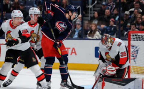 Feb 24, 2020; Columbus, Ohio, USA; Ottawa Senators defenseman Nikita Zaitsev (22) skates as Columbus Blue Jackets forward Calvin Thurkauf (48) attempts to play the puck against Ottawa Senators goaltender Marcus Hogberg (35) in the first period at Nationwide Arena. Mandatory Credit: Aaron Doster-USA TODAY Sports