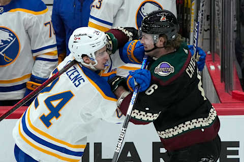 Jan 29, 2022; Glendale, Arizona, USA; Buffalo Sabres center Dylan Cozens (24) and Arizona Coyotes defenseman Jakob Chychrun (6) shove each other in the third period at Gila River Arena. Mandatory Credit: Rick Scuteri-USA TODAY Sports