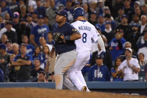 LOS ANGELES, CA – OCTOBER 16: Manny Machado #8 of the Los Angeles Dodgers is out a first base by Jesus Aguilar #24 of the Milwaukee Brewers during the tenth inning in Game Four of the National League Championship Series at Dodger Stadium on October 16, 2018 in Los Angeles, California. (Photo by Harry How/Getty Images)