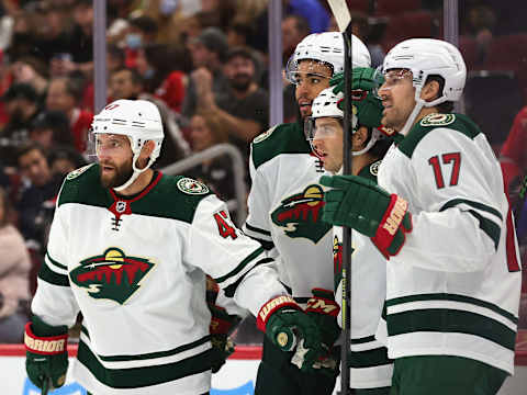 CHICAGO, ILLINOIS – OCTOBER 09: Ryan Hartman #38 of the Minnesota Wild (center) is congratulated by (L-R) Alex Goligoski #4, Jordan Greenway #18 and Marcus Foligno #17 after scoring a first period goal against the Chicago Blackhawks during a preseason game at the United Center on October 09, 2021 in Chicago, Illinois. (Photo by Jonathan Daniel/Getty Images)