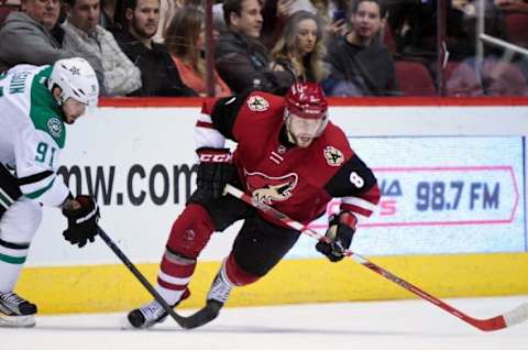 Feb 18, 2016; Glendale, AZ, USA; Dallas Stars center Tyler Seguin (91) trips Arizona Coyotes center Tobias Rieder (8) during the second period at Gila River Arena. Mandatory Credit: Matt Kartozian-USA TODAY Sports