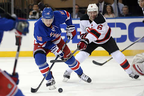 Sep 29, 2016; New York, NY, USA; New York Rangers right wing Jesper Fast (19) plays the puck against New Jersey Devils defenseman Andy Greene (6) during the first period of a preseason hockey game at Madison Square Garden. Mandatory Credit: Brad Penner-USA TODAY Sports