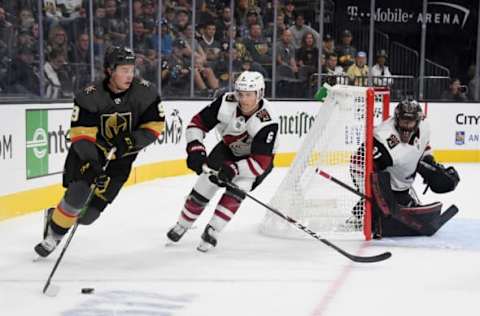 LAS VEGAS, NEVADA – SEPTEMBER 15: Cody Glass #9 of the Vegas Golden Knights skates with the puck against Jakob Chychrun #6 of the Arizona Coyotes as Adin Hill #31 of the Coyotes tends net in the second period of their preseason game at T-Mobile Arena on September 15, 2019 in Las Vegas, Nevada. The Golden Knights defeated the Coyotes 6-2. (Photo by Ethan Miller/Getty Images)