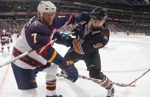 WASHINGTON – OCTOBER 07: Center Dainius Zubrus #9 of the Washington Capitals battles for the puck with Defenseman Greg deVries #7 of the Atlanta Thrashers during the NHL game on October 7, 2005 at MCI Center in Washington, D.C. The Thrashers defeated the Captials 7-3. (Photo by Mitchell Layton/Getty Images)