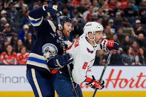 Jan 5, 2023; Columbus, Ohio, USA; Columbus Blue Jackets defenseman Vladislav Gavrikov (4) battles for position against Washington Capitals left wing Alex Ovechkin (8) in the first period at Nationwide Arena. Mandatory Credit: Aaron Doster-USA TODAY Sports