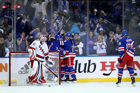 New York Rangers center Tyler Motte (64) celebrates his goal against Carolina Hurricanes goaltender Antti Raanta (32) with teammates during the first period Credit: Brad Penner-USA TODAY Sports