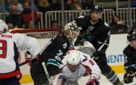 Washington Capitals left wing Alex Ovechkin (8) collides with San Jose Sharks goalie Martin Jones (31) (Neville E. Guard-USA TODAY Sports)