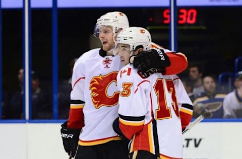 Oct 25, 2016; St. Louis, MO, USA; Calgary Flames left wing Johnny Gaudreau (13) is congratulated by center Matt Stajan (18) after scoring an empty net goal against the St. Louis Blues during the third period at Scottrade Center. The Flames won 4-1. Mandatory Credit: Jeff Curry-USA TODAY Sports