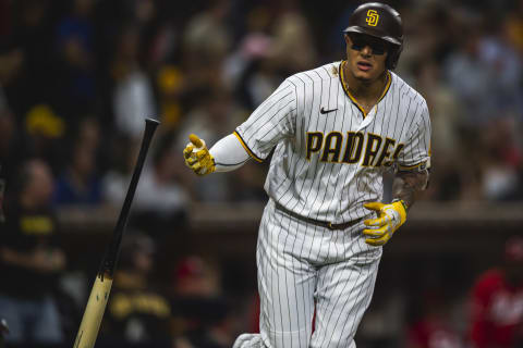 Manny Machado #13 of the San Diego Padres hits a home run in the seventh inning against the Cincinnati Reds on June 17, 2021 at Petco Park in San Diego, California. Tonight’s game is the first game of the season at full capacity for fans at Petco Park. (Photo by Matt Thomas/San Diego Padres/Getty Images)