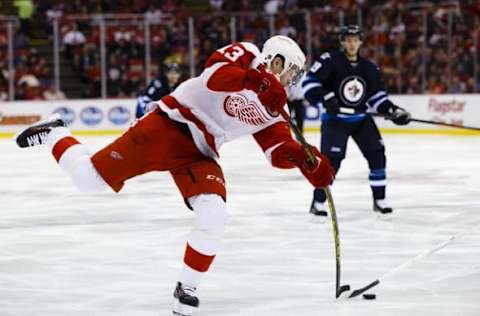 Mar 10, 2016; Detroit, MI, USA; Detroit Red Wings center Pavel Datsyuk (13) takes a shot in the third period against the Winnipeg Jets at Joe Louis Arena. Detroit won 3-2. Mandatory Credit: Rick Osentoski-USA TODAY Sports