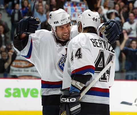 Ed Jovanovski of the Vancouver Canucks, left, hugs teammate Todd Bertuzzi Photo by Jeff Vinnick/Getty Images/NHLI)