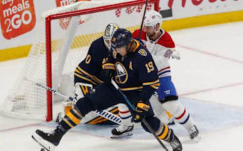 BUFFALO, NY – OCTOBER 09: Jake McCabe #19 of the Buffalo Sabres blocks a shot with Tomas Tatar #90 of the Montreal Canadiens looking for the rebound in front of Carter Hutton #40 of the Buffalo Sabres during the third period at KeyBank Center on October 9, 2019 in Buffalo, New York. (Photo by Nicholas T. LoVerde/Getty Images)