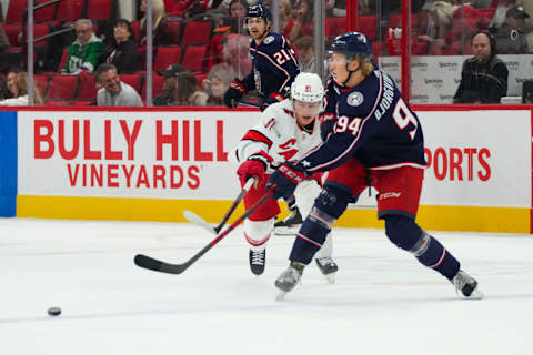 Oct 3, 2022; Raleigh, North Carolina, USA; Columbus Blue Jackets defenseman Ole Julian Bjorgvik-Holm (94) gets the pass away against Carolina Hurricanes center Jamieson Rees (81) during the third period at PNC Arena. Mandatory Credit: James Guillory-USA TODAY Sports