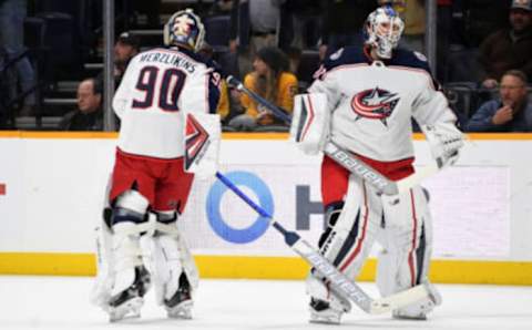 Nov 30, 2021; Nashville, Tennessee, USA; Columbus Blue Jackets goaltender Elvis Merzlikins (90) is taken out of the game and replaced by Columbus Blue Jackets goaltender Joonas Korpisalo (70) during the first period against the Nashville Predators at Bridgestone Arena. Mandatory Credit: Christopher Hanewinckel-USA TODAY Sports