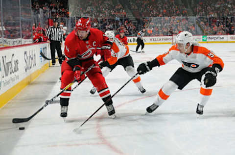 PHILADELPHIA, PA – JANUARY 03: Justin Williams #14 of the Carolina Hurricanes skates the puck against Ivan Provorov #9 of the Philadelphia Flyers on January 3, 2019 at the Wells Fargo Center in Philadelphia, Pennsylvania. (Photo by Len Redkoles/NHLI via Getty Images)