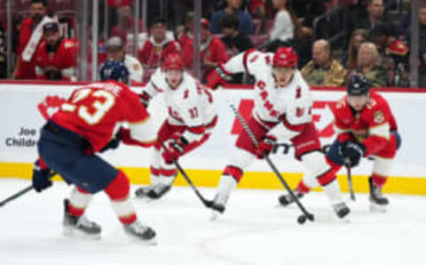 Nov 10, 2023; Sunrise, Florida, USA; Carolina Hurricanes left wing Teuvo Teravainen (86) plays the puck in front of Florida Panthers center Anton Lundell (15) during the first period at Amerant Bank Arena. Mandatory Credit: Jasen Vinlove-USA TODAY Sports