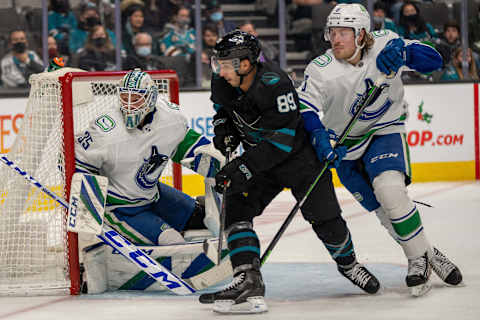 Dec 16, 2021; San Jose, California, USA; San Jose Sharks left wing Jayden Halbgewachs (89) and Vancouver Canucks right wing Brock Boeser (6) battle for position in front of the net during the second period at SAP Center at San Jose. Mandatory Credit: Neville E. Guard-USA TODAY Sports