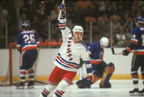 Ron Greschner of the New York Rangers raises his stick in celebration of a goal (Photo by Bruce Bennett Studios via Getty Images Studios/Getty Images)