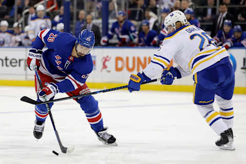 Apr 10, 2023; New York, New York, USA; New York Rangers left wing Chris Kreider (20) controls the puck against Buffalo Sabres defenseman Rasmus Dahlin (26) during the second period at Madison Square Garden. Mandatory Credit: Brad Penner-USA TODAY Sports