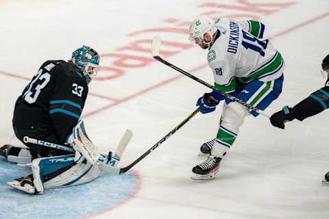 Dec 16, 2021; San Jose, California, USA; San Jose Sharks goaltender Adin Hill (33) makes a save against Vancouver Canucks center Jason Dickinson (18) during the third period at SAP Center at San Jose. Mandatory Credit: Neville E. Guard-USA TODAY Sports