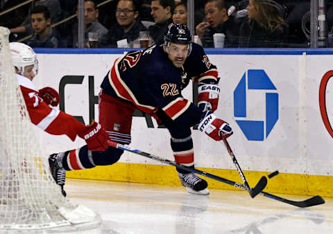 Apr 9, 2016; New York, NY, USA; New York Rangers defenseman Dan Boyle (22) clears the puck in front of Detroit Red Wings center Dylan Larkin (71) during the third period at Madison Square Garden. The Rangers defeated the Red Wings 3-2. Mandatory Credit: Adam Hunger-USA TODAY Sports