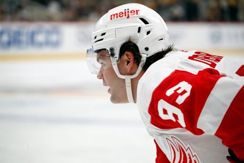 Oct 4, 2023; Pittsburgh, Pennsylvania, USA; Detroit Red Wings right wing Alex DeBrincat (93) looks on at the face-off circle against the Pittsburgh Penguins during the third period at PPG Paints Arena. Detroit won 2-1. Mandatory Credit: Charles LeClaire-USA TODAY Sports