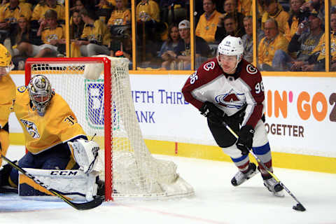 NASHVILLE, TN – APRIL 12: Nashville Predators goalie Pekka Rinne (35) slides across the crease as Colorado Avalanche right wing Mikko Rantanen (96) skates behind the goal with the puck during Game One of Round One of the Stanley Cup Playoffs between the Nashville Predators and Colorado Avalanche, held on April 12, 2018, at Bridgestone Arena in Nashville, Tennessee. (Photo by Danny Murphy/Icon Sportswire via Getty Images)