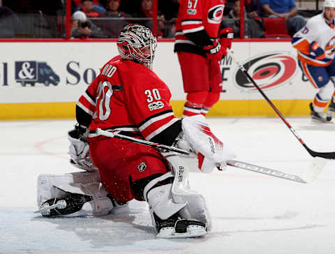 RALEIGH, NC – NOVEMBER 19: Cam Ward #30 of the Carolina Hurricanes goes down in the crease and keeps his eye on the puck during an NHL game against the New York Islanders on November 19, 2017 at PNC Arena in Raleigh, North Carolina. (Photo by Gregg Forwerck/NHLI via Getty Images)