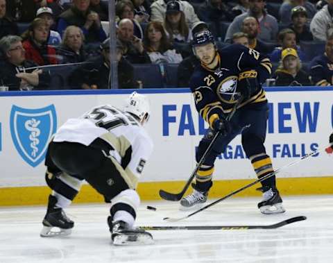 Feb 21, 2016; Buffalo, NY, USA; Buffalo Sabres center Sam Reinhart (23) takes a shot as Pittsburgh Penguins defenseman Derrick Pouliot (51) defends during the second period at First Niagara Center. Mandatory Credit: Kevin Hoffman-USA TODAY Sports