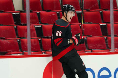 Jan 28, 2021; Raleigh, North Carolina, USA; Carolina Hurricanes center Martin Necas (88) scores the game winning goal in the overtime against the Tampa Bay Lightning at PNC Arena. Mandatory Credit: James Guillory-USA TODAY Sports