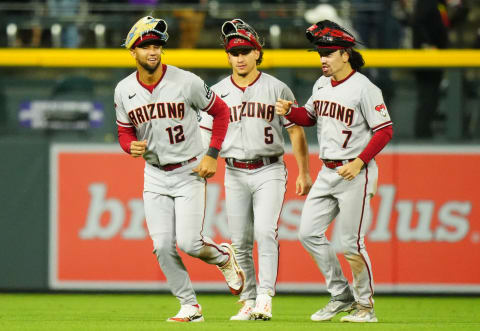 Apr 28, 2023; Denver, Colorado, USA; Arizona Diamondbacks left fielder Lourdes Gurriel Jr. (12), center fielder Alek Thomas (5) and right fielder Corbin Carroll (7) celebrate defeating the Colorado Rockies at Coors Field. Mandatory Credit: Ron Chenoy-USA TODAY Sports