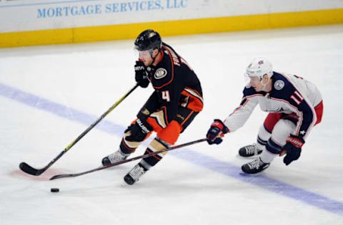 ANAHEIM, CA: Columbus Blue Jackets left wing Matt Calvert (11) tries to take the puck away from Anaheim Ducks defenseman Cam Fowler (4) during the second period on March 2, 2018. (Photo by John Cordes/Icon Sportswire via Getty Images)