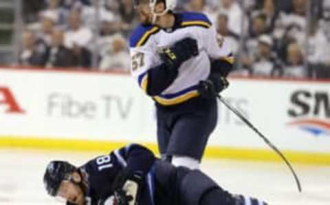 WINNIPEG, MANITOBA – APRIL 18: Bryan Little #18 of the Winnipeg Jets gets up from the ice after a check from David Perron #57 of the St. Louis Blues in Game Five of the Western Conference First Round during the 2019 NHL Stanley Cup Playoffs at Bell MTS Place on April 18, 2019 in Winnipeg, Manitoba, Canada. (Photo by Jason Halstead/Getty Images)