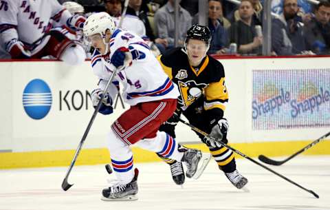 Dec 20, 2016; Pittsburgh, PA, USA; New York Rangers right wing Jesper Fast (19) reacts after stealing the puck from Pittsburgh Penguins defenseman Olli Maatta (3) during the third period at the PPG PAINTS Arena. The Penguins won 7-2. Mandatory Credit: Charles LeClaire-USA TODAY Sports