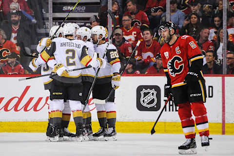 CALGARY, AB – MARCH 8: Nick Holden #22 (C) of the Vegas Golden Knights celebrates with his teammates after scoring against the Calgary Flames during an NHL game at Scotiabank Saddledome on March 8, 2020 in Calgary, Alberta, Canada. (Photo by Derek Leung/Getty Images)