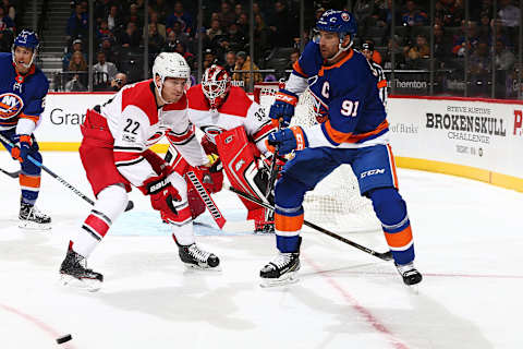 NEW YORK, NY – NOVEMBER 16: John Tavares #91 of the New York Islanders plays the puck against Brett Pesce #22 of the Carolina Hurricanes at Barclays Center on November 16, 2017 in New York City. (Photo by Mike Stobe/NHLI via Getty Images)