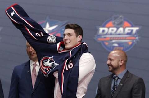 CHL Player Rankings: Pierre-Luc Dubois puts on a team jersey after being selected as the number three overall draft pick by the Columbus Blue Jackets in the first round of the 2016 NHL Draft at the First Niagra Center. Mandatory Credit: Timothy T. Ludwig-USA TODAY Sports