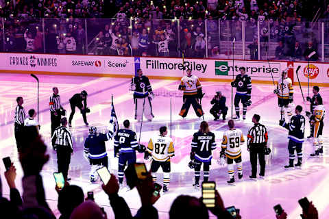 Winnipeg Jets and Pittsburgh Penguins players raise their sticks Mandatory Credit: James Carey Lauder-USA TODAY Sports