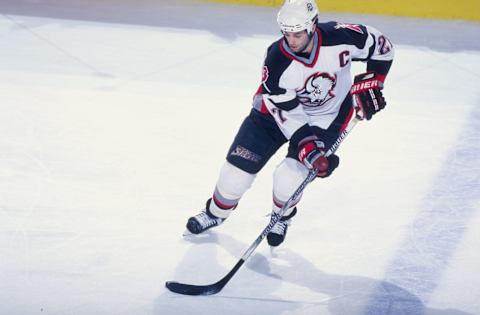 15 Feb 1999: Michael Peca #27 of the Buffalo Sabres controls the puck during the game against the Carolina Hurricanes at the Marine Midland Arena in Buffalo, New York. The Sabres defeated the Hurricanes 3-2.