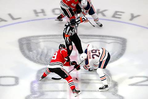 EDMONTON, ALBERTA – AUGUST 07: Jonathan Toews #19 of the Chicago Blackhawks and Leon Draisaitl #29 of the Edmonton Oilers battle for the face-off to begin the third period in Game Four of the Western Conference Qualification Round prior to the 2020 NHL Stanley Cup Playoffs at Rogers Place on August 07, 2020 in Edmonton, Alberta. (Photo by Jeff Vinnick/Getty Images)