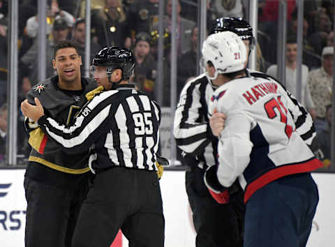 Linesman Jonny Murray holds Ryan Reaves of the Vegas Golden Knights back from Garnet Hathaway of the Washington Capitals after the two teams scuffled in the third period.