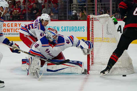 Mar 20, 2022; Raleigh, North Carolina, USA; New York Rangers goaltender Alexandar Georgiev (40) and defenseman Braden Schneider (45) watch the puck during the first period at PNC Arena. Mandatory Credit: James Guillory-USA TODAY Sports