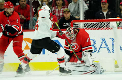 RALEIGH, NC – NOVEMBER 2: Kevin Rooney #16 of the New Jersey Devils takes a shot on goal as James Reimer #47 goes down in the crease to make the save during an NHL game on November 2, 2019 at PNC Arena in Raleigh, North Carolina. (Photo by Gregg Forwerck/NHLI via Getty Images)