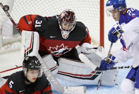 VICTORIA , BC – DECEMBER 21: Ian Scott #31 of Team Canada makes a save as Andrej Kukuca #28 of Team Slovakia   (Photo by Kevin Light/Getty Images)