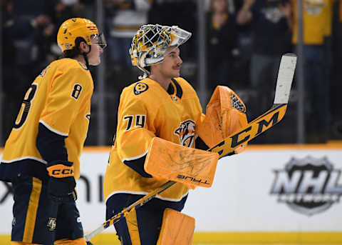 Apr 13, 2023; Nashville, Tennessee, USA; Nashville Predators goaltender Juuse Saros (74) is congratulated by center Cody Glass (8) after an overtime win against the Minnesota Wild at Bridgestone Arena. Mandatory Credit: Christopher Hanewinckel-USA TODAY Sports