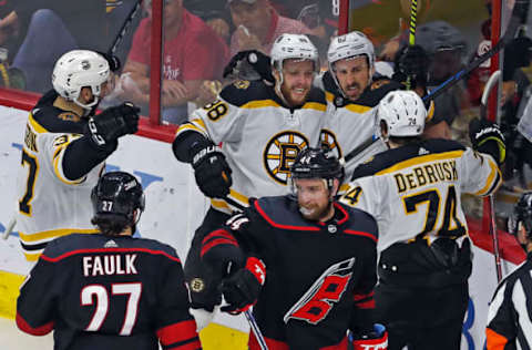 RALEIGH – MAY 16: After the Bruins David Pastrnak (88) put the puck past Hurricanes goalie Curtis McElhinney, giving Boston a 1-0 second period lead, he celebrate with teammates Patrice Bergeron, Brad Marchand and Jake DeBrusk. The Boston Bruins visited the Carolina Hurricanes for Game Four of the Stanley Cup Eastern Conference Finals NHL playoff series at PNC Arena in Raleigh, North Carolina. (Photo by Jim Davis/The Boston Globe via Getty Images)