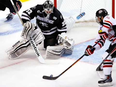 Apr 9, 2015; Boston, MA, USA; Providence College Friars goaltender Jon Gillies (32) watches a rebound against Nebraska-Omaha Mavericks forward Tyler Vessel (10) during the first period of a semifinal game in the men